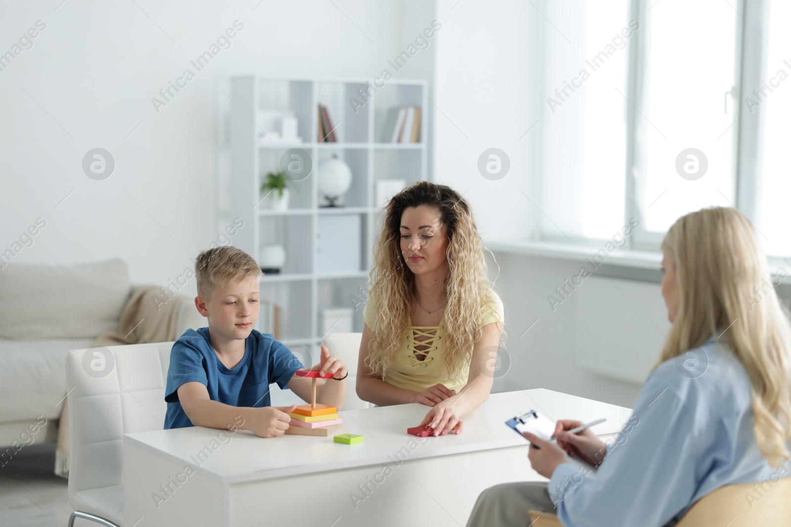 Mother and son having consultation with psychologist in office, selective focus Photo of Mother and son having consultation with psychologist in office, selective focus