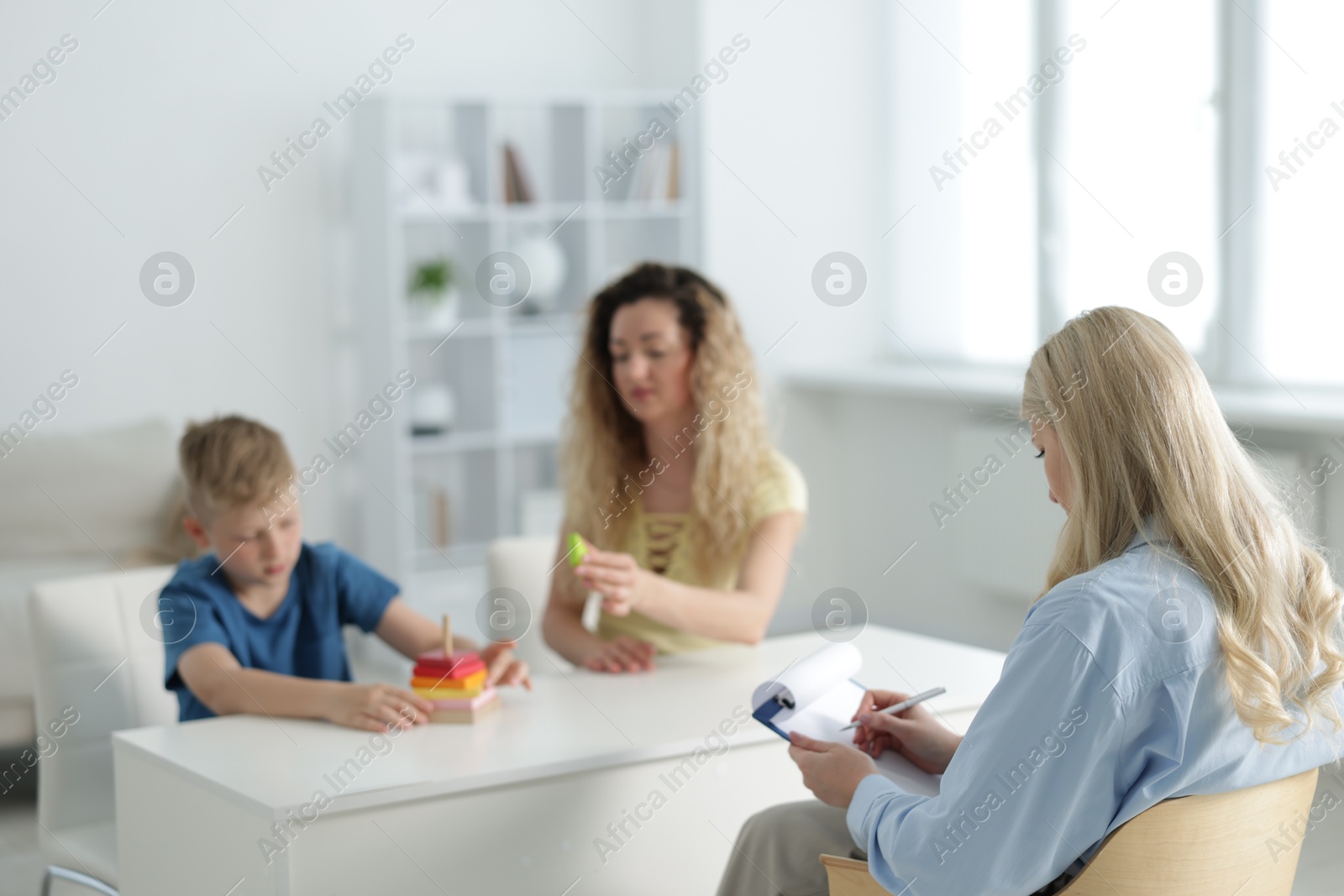 Mother and son having consultation with psychologist in office, selective focus Photo of Mother and son having consultation with psychologist in office, selective focus