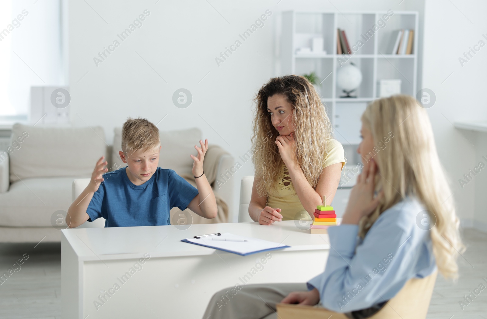 Mother and son having consultation with psychologist in office, selective focus Photo of Mother and son having consultation with psychologist in office, selective focus