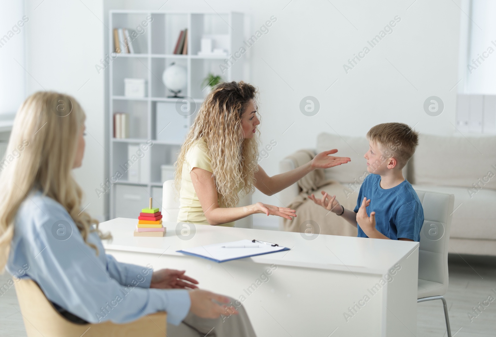 Mother and son having consultation with psychologist in office, selective focus Photo of Mother and son having consultation with psychologist in office, selective focus