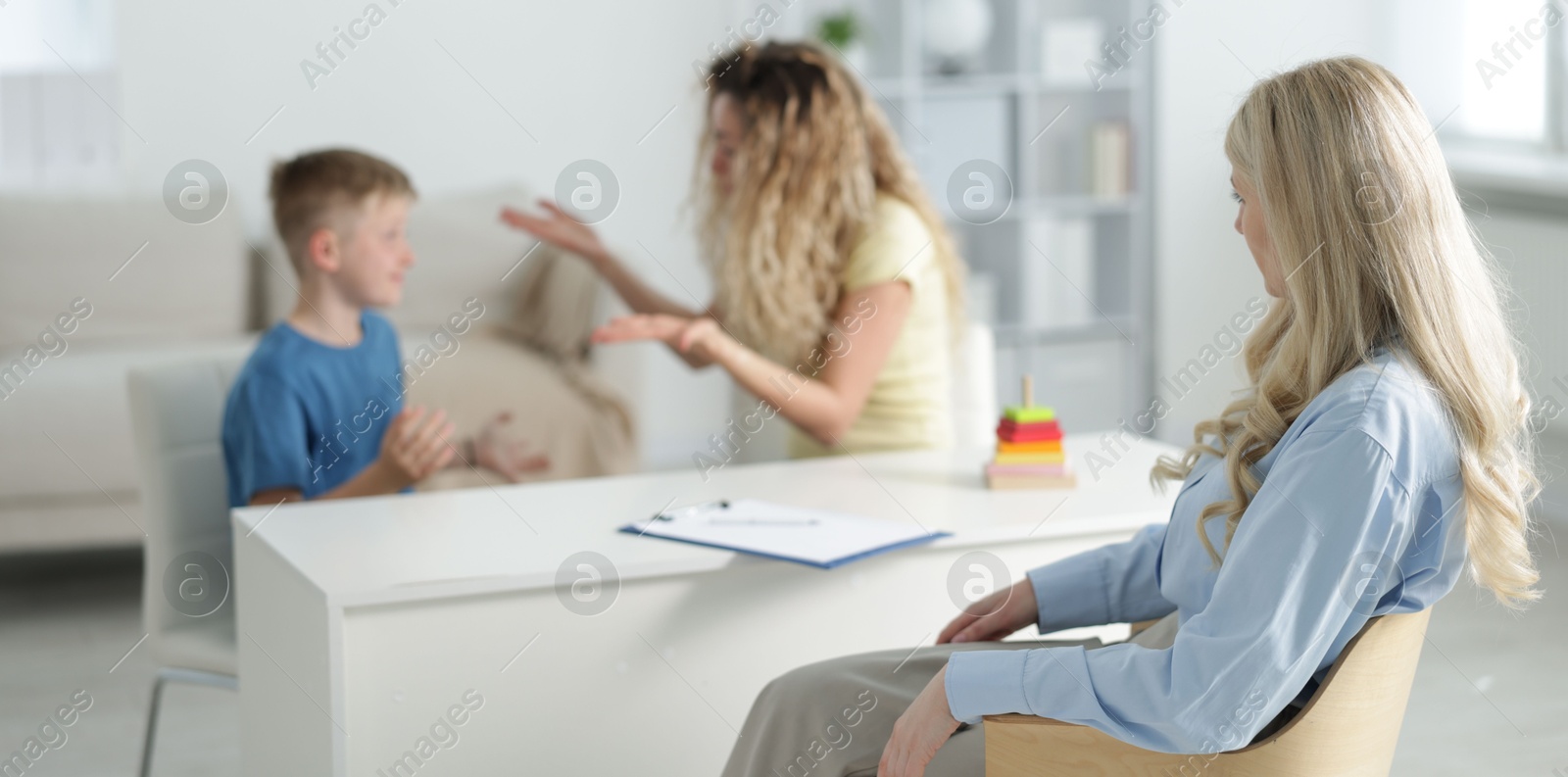 Mother and son having consultation with psychologist in office, selective focus Photo of Mother and son having consultation with psychologist in office, selective focus