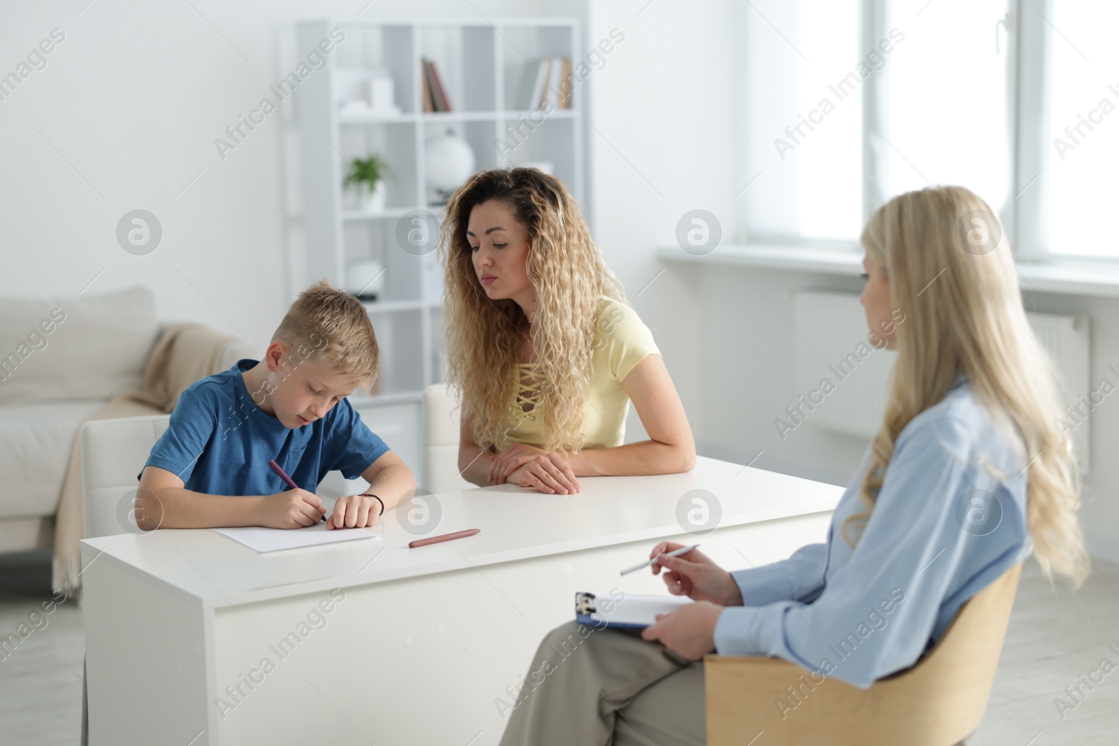 Mother and son having consultation with psychologist in office, selective focus Photo of Mother and son having consultation with psychologist in office, selective focus