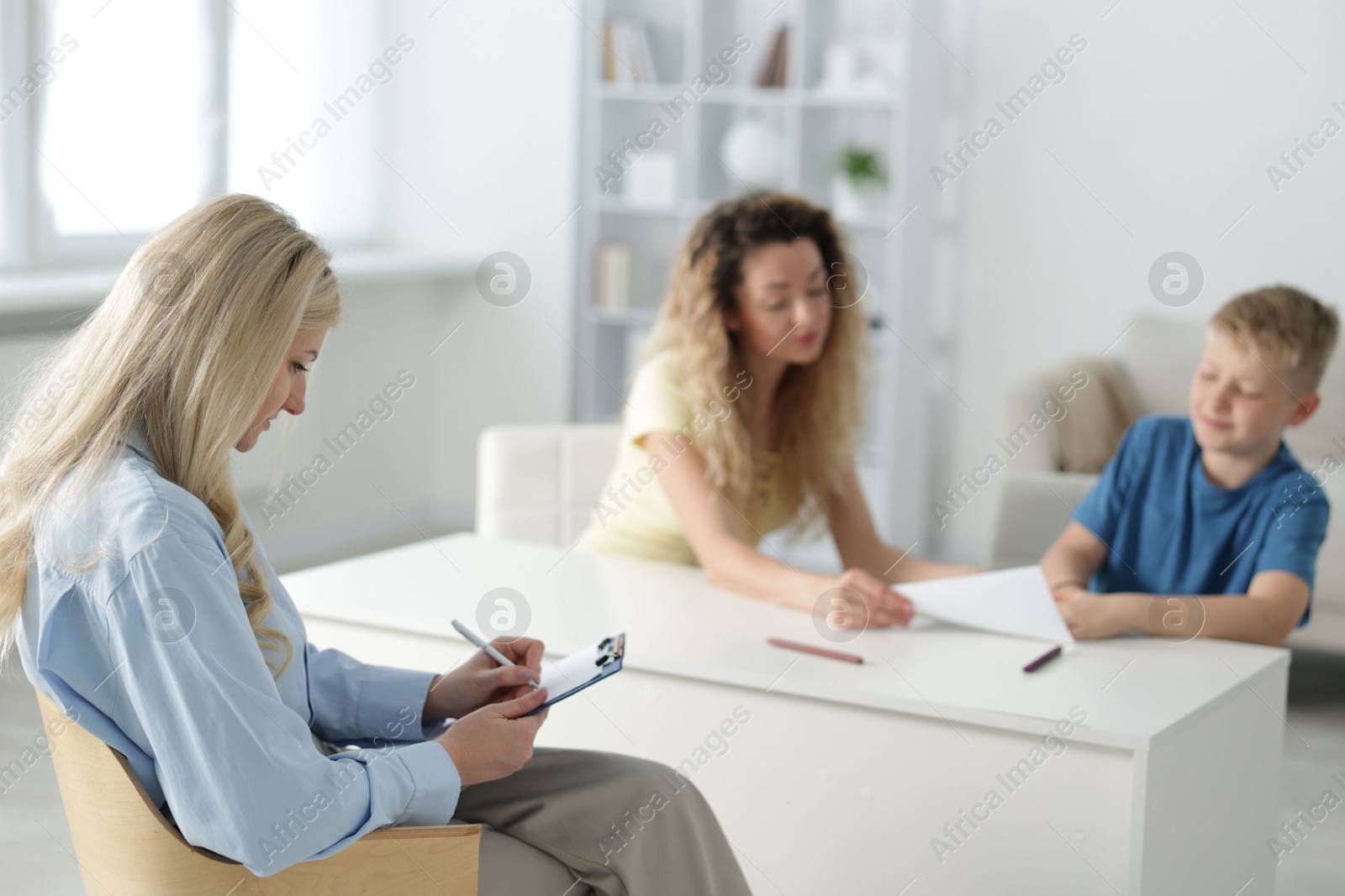 Mother and son having consultation with psychologist in office, selective focus Photo of Mother and son having consultation with psychologist in office, selective focus