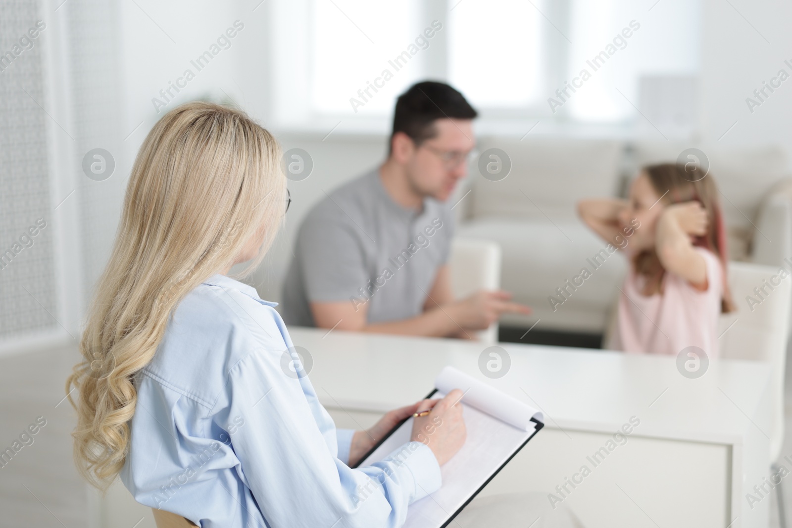 Father and daughter having consultation with psychologist in office, selective focus Photo of Father and daughter having consultation with psychologist in office, selective focus