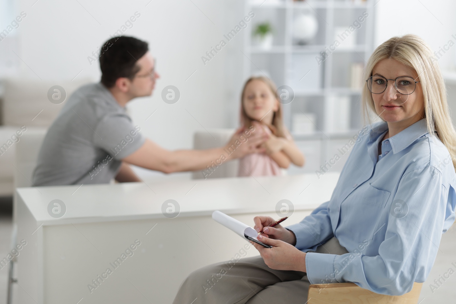 Father and daughter having consultation with psychologist in office, selective focus Photo of Father and daughter having consultation with psychologist in office, selective focus