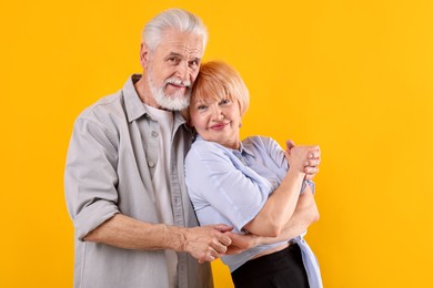 Photo of Lovely senior couple together on yellow background