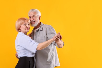 Photo of Lovely senior couple together on yellow background, space for text