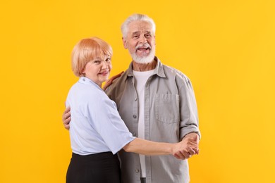 Photo of Lovely senior couple together on yellow background