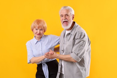 Photo of Lovely senior couple together on yellow background