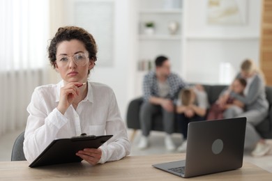 Photo of Family psychologist working in office, selective focus