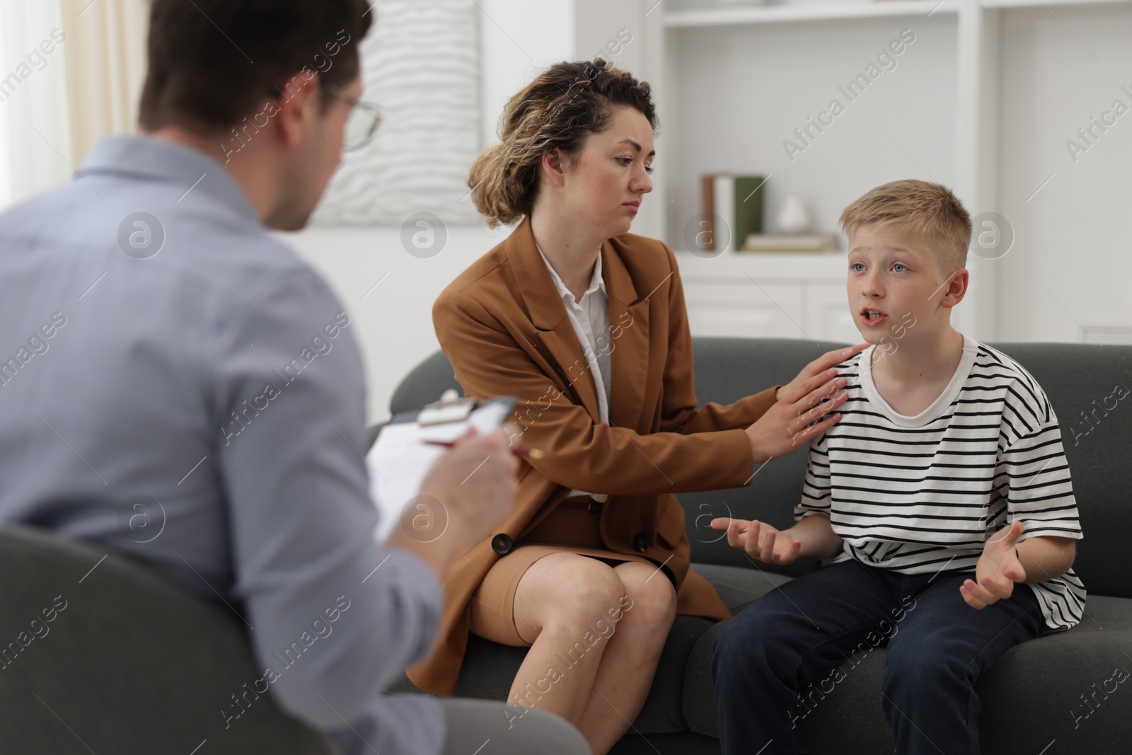 Mother and son having consultation with psychologist in office, selective focus Photo of Mother and son having consultation with psychologist in office, selective focus