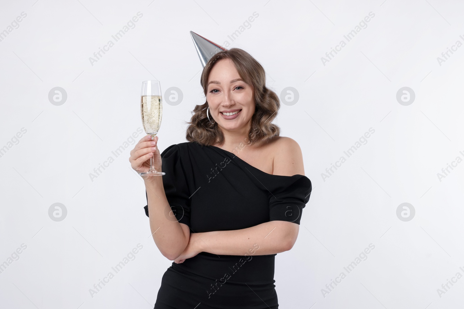 Birthday celebration. Woman with glass of sparkling wine on white background Photo of Birthday celebration. Woman with glass of sparkling wine on white background