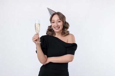 Photo of Birthday celebration. Woman with glass of sparkling wine on white background