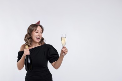 Photo of Birthday celebration. Woman with sparkling wine on white background. Space for text