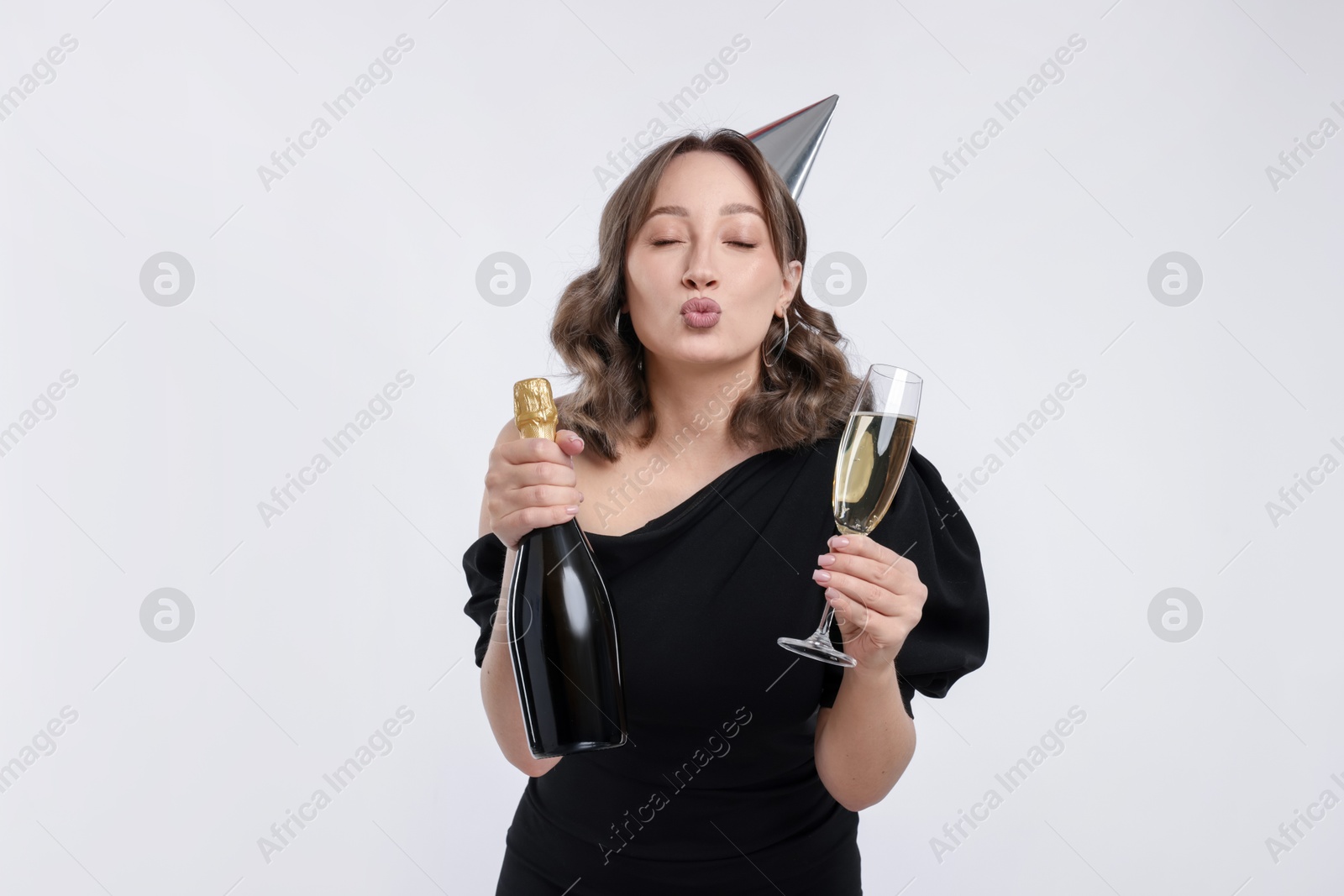 Birthday celebration. Woman with sparkling wine on white background Photo of Birthday celebration. Woman with sparkling wine on white background