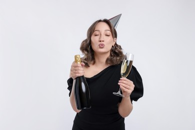 Photo of Birthday celebration. Woman with sparkling wine on white background