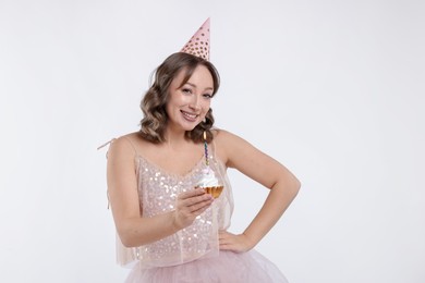 Photo of Birthday celebration. Woman with cupcake on white background