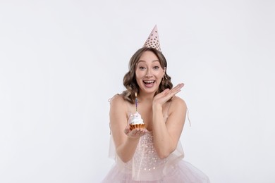 Photo of Birthday celebration. Woman with cupcake on white background