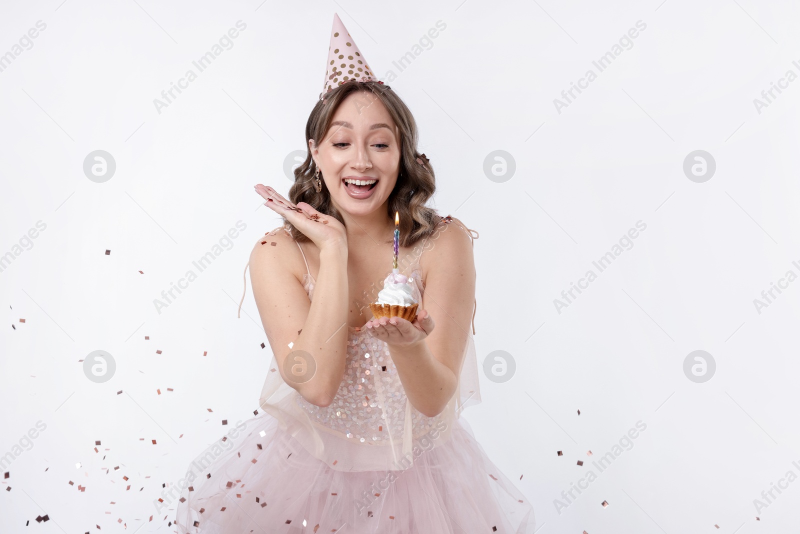 Birthday celebration. Woman with cupcake on white background Photo of Birthday celebration. Woman with cupcake on white background