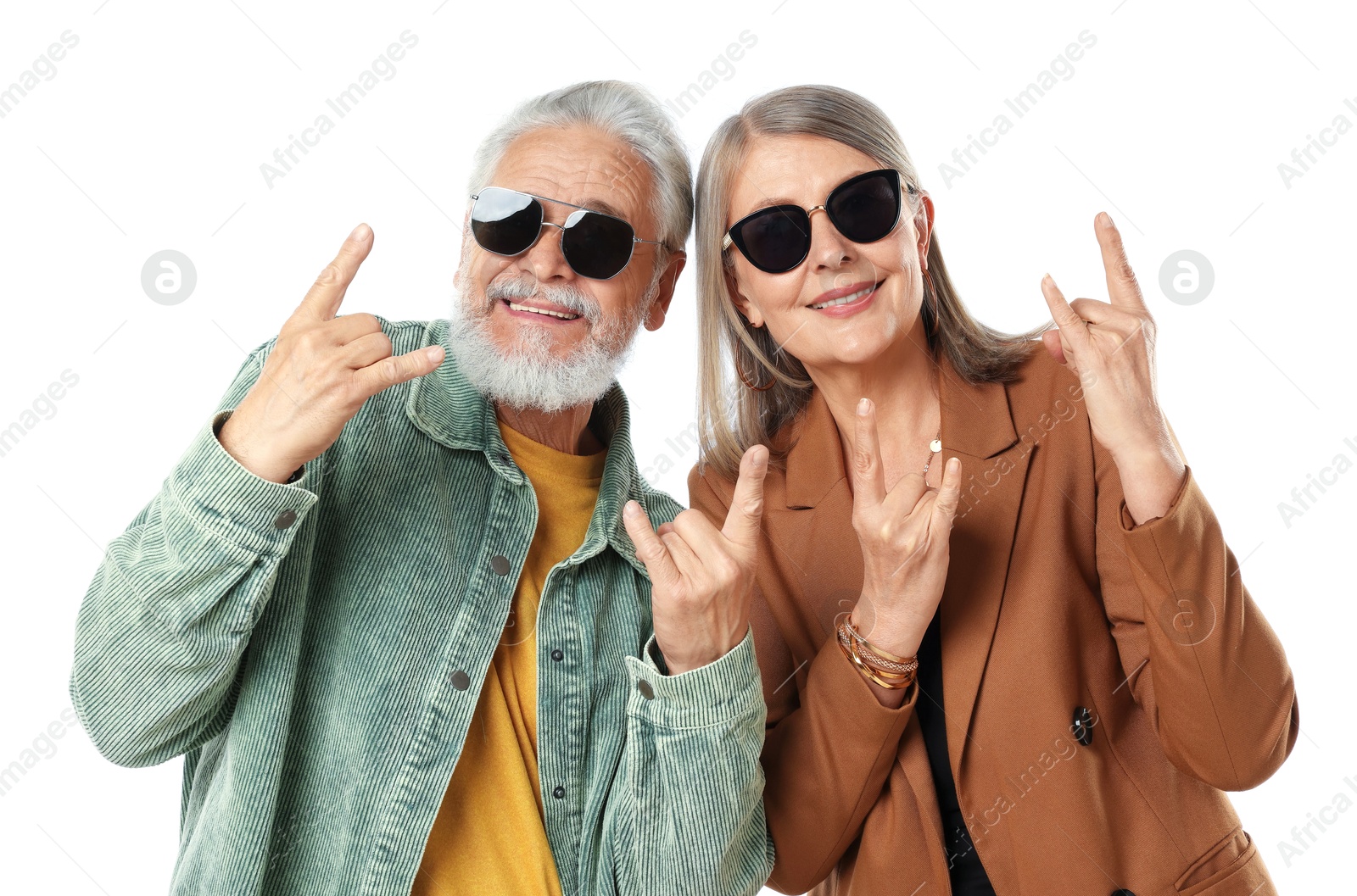 Senior couple in stylish outfits making rock gestures on white background Photo of Senior couple in stylish outfits making rock gestures on white background