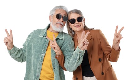 Photo of Senior couple in stylish outfits showing V-signs on white background