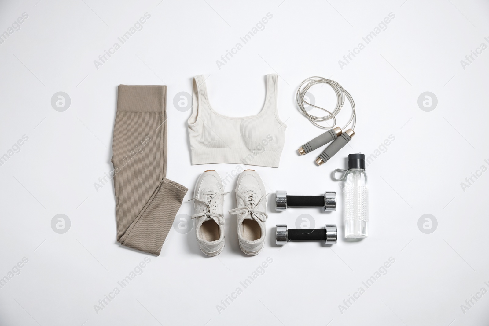 Sportswear, sneakers, dumbbells, skipping rope and water bottle on white background, flat lay Photo of Sportswear, sneakers, dumbbells, skipping rope and water bottle on white background, flat lay