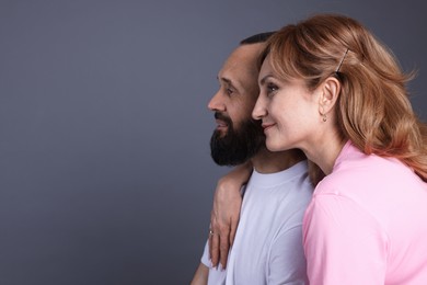 Photo of Portrait of lovely couple on grey background, space for text