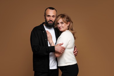 Photo of Portrait of lovely couple on brown background