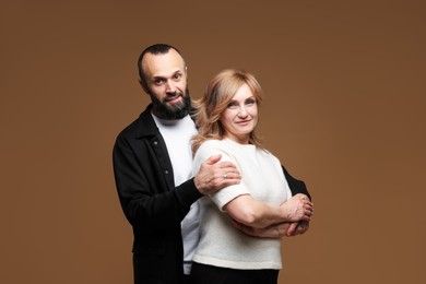 Photo of Portrait of lovely couple on brown background