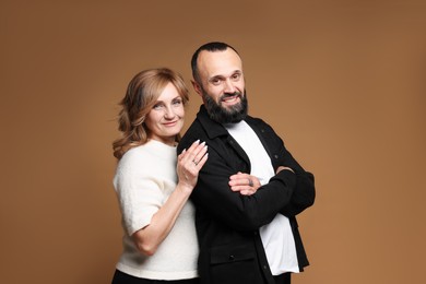 Photo of Portrait of lovely couple on brown background