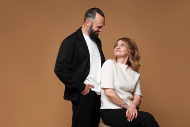 Photo of Portrait of lovely couple on brown background
