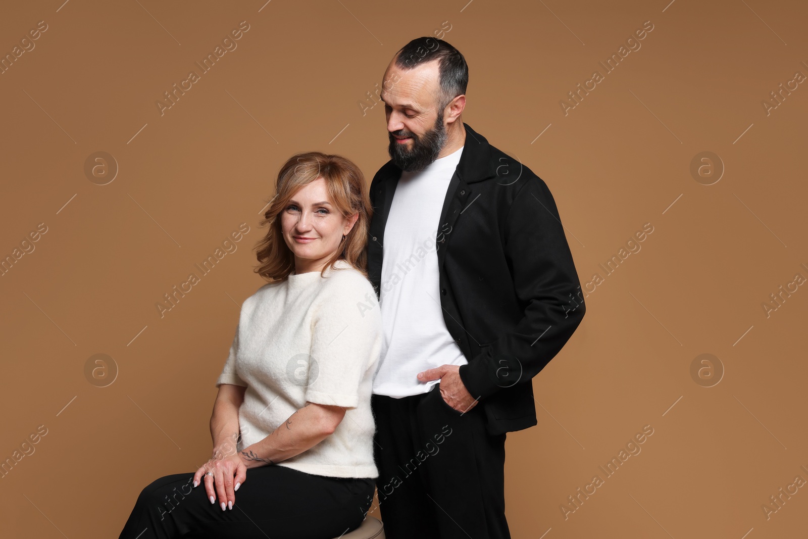 Portrait of lovely couple on brown background Photo of Portrait of lovely couple on brown background