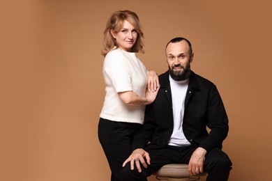 Photo of Portrait of lovely couple on brown background