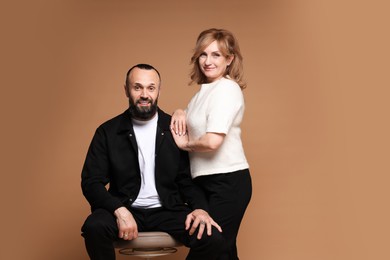 Photo of Portrait of lovely couple on brown background