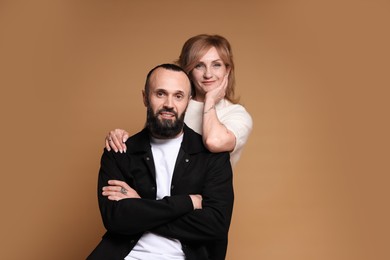 Photo of Portrait of lovely couple on brown background