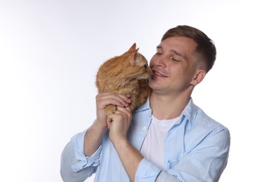 Photo of Man with cute ginger cat on white background