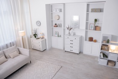 Photo of Stylish living room interior. Sofa, dresser, shelving unit and other furniture indoors, above view