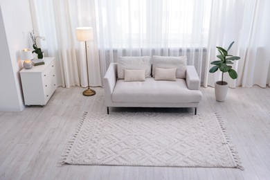 Photo of Stylish living room interior. Sofa, dresser, shelving unit and other furniture indoors, above view