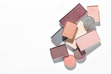 Photo of Beautiful eyeshadow refill pans on white background, flat lay. Space for text