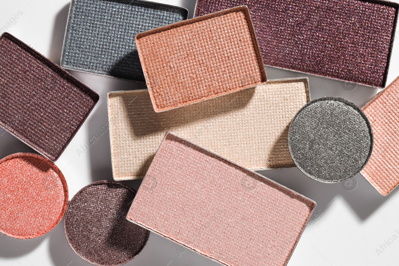 Beautiful eyeshadow refill pans on white background, flat lay Photo of Beautiful eyeshadow refill pans on white background, flat lay