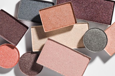 Photo of Beautiful eyeshadow refill pans on white background, flat lay