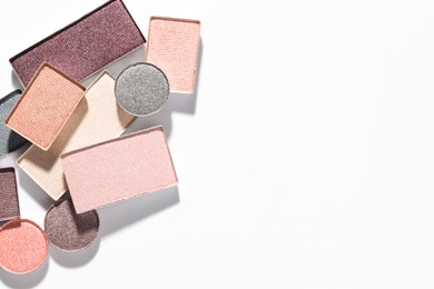 Photo of Beautiful eyeshadow refill pans on white background, flat lay. Space for text