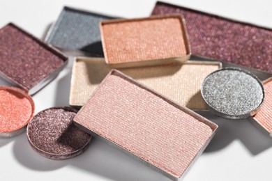 Photo of Beautiful eyeshadow refill pans on white background, closeup