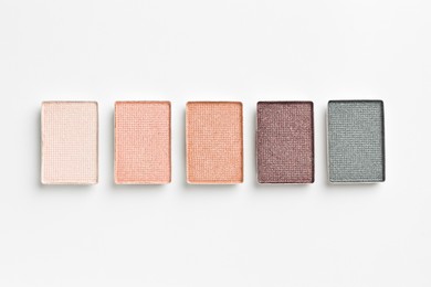 Photo of Beautiful eyeshadow refill pans on white background, flat lay