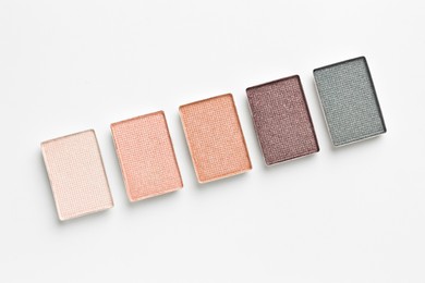 Photo of Beautiful eyeshadow refill pans on white background, flat lay