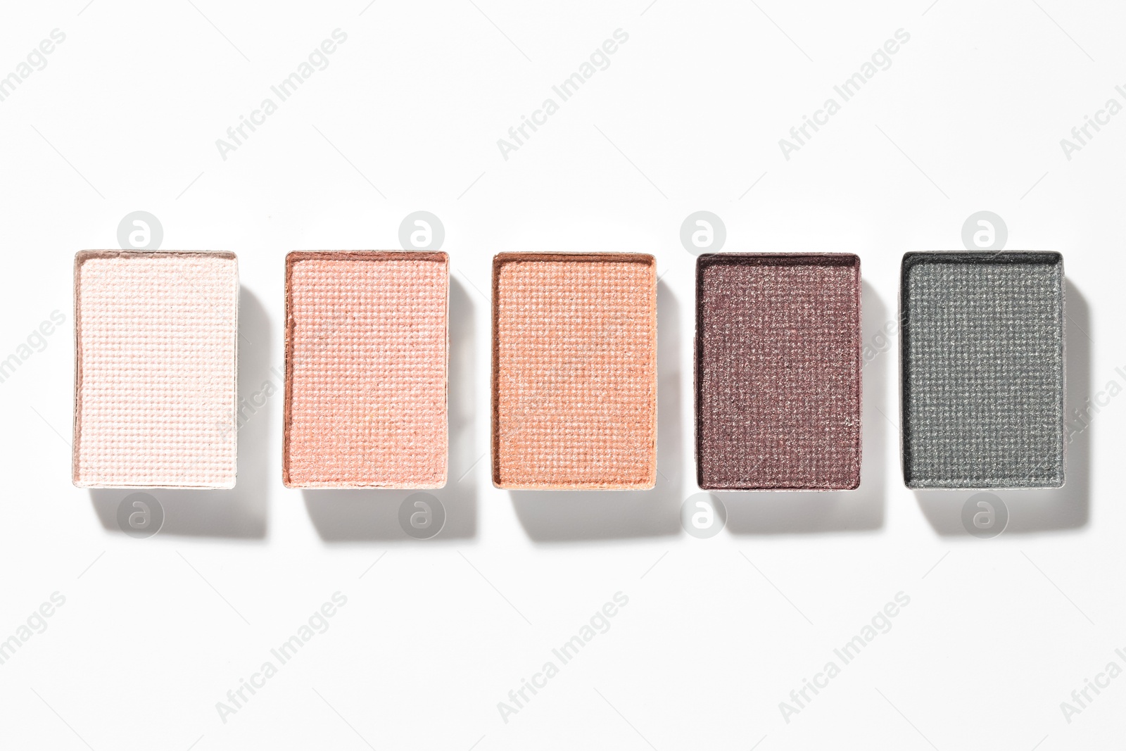 Beautiful eyeshadow refill pans on white background, flat lay Photo of Beautiful eyeshadow refill pans on white background, flat lay