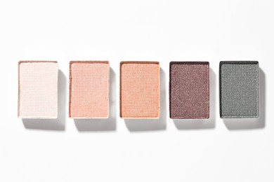 Photo of Beautiful eyeshadow refill pans on white background, flat lay