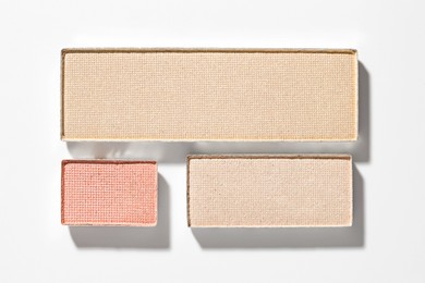 Photo of Beautiful eyeshadow refill pans on white background, flat lay