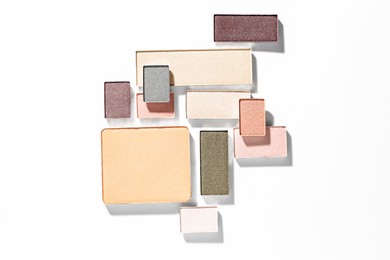 Photo of Beautiful eyeshadow refill pans on white background, flat lay