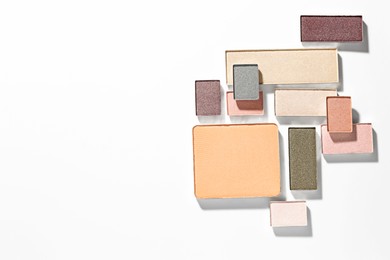 Photo of Beautiful eyeshadow refill pans on white background, flat lay. Space for text